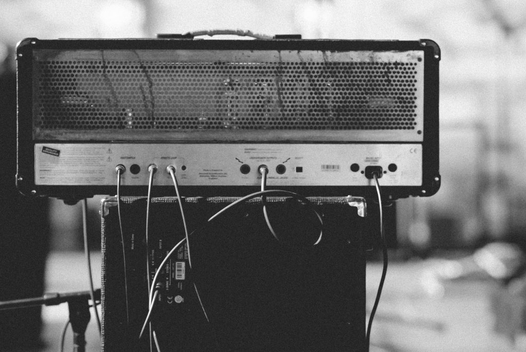 The back of an amplifier head with cables running from it