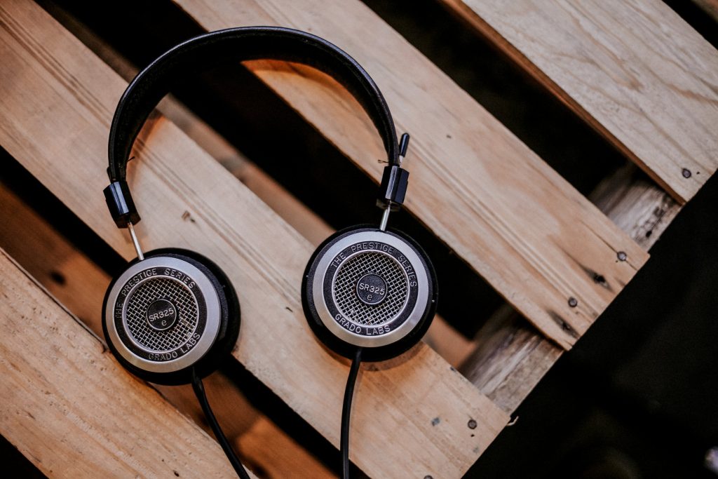 A pair of headphones resting on bare wood